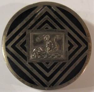 Pillbox, with enameled lid and relief figure.