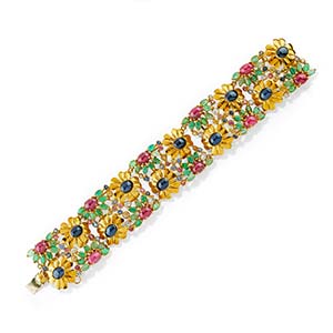 A 18K yellow gold, emerald, ruby, ... 