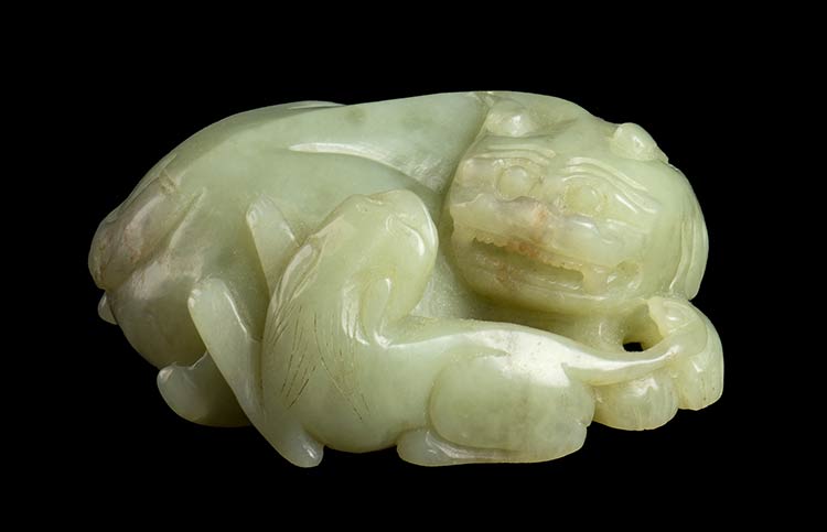 A PALE GREEN JADE LION AND ... 