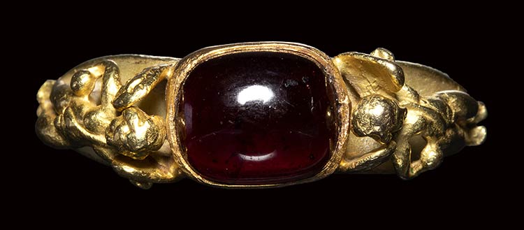 A modern gold ring with a garnet ... 