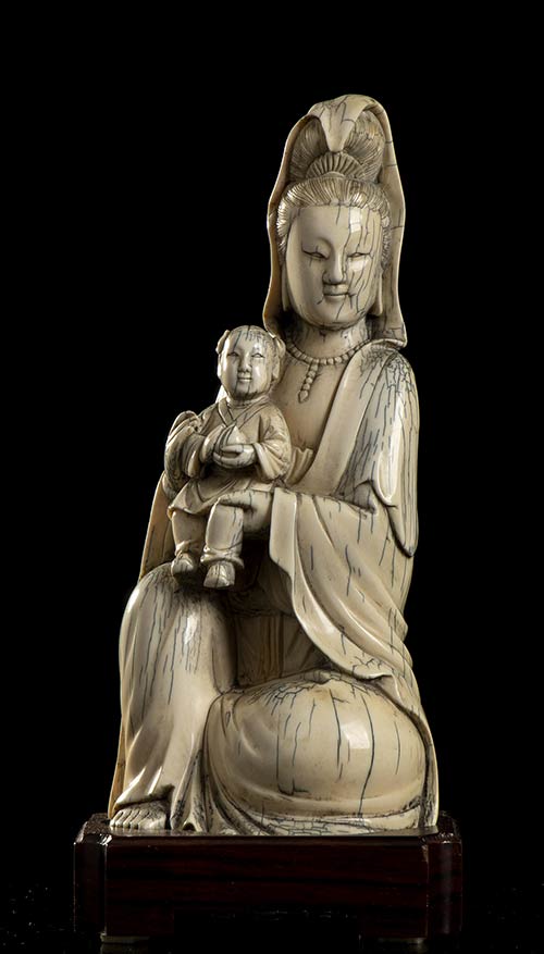 AN IVORY GUANYIN WITH ... 