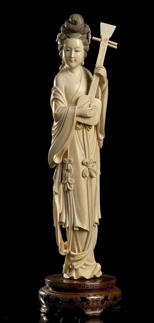 AN IVORY FEMALE FIGURE WITH AN ... 
