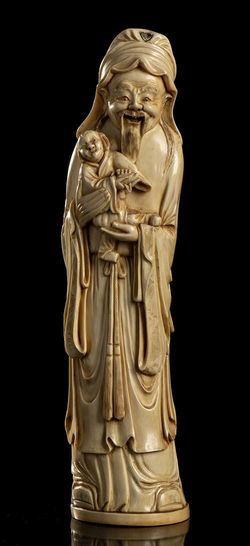 AN IVORY DEITY WITH CHILD
China, ... 
