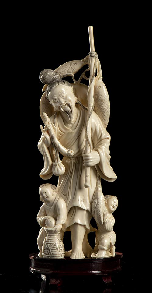 AN IVORY FISHERMAN WITH ... 