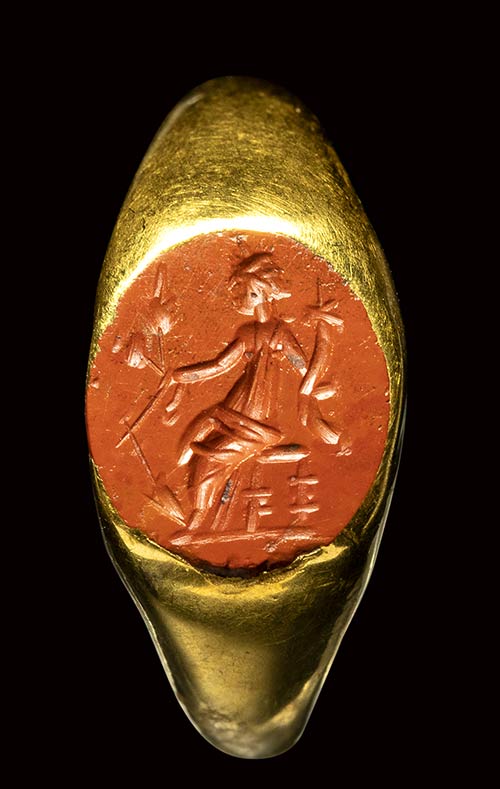 A roman gold ring set with a red ... 