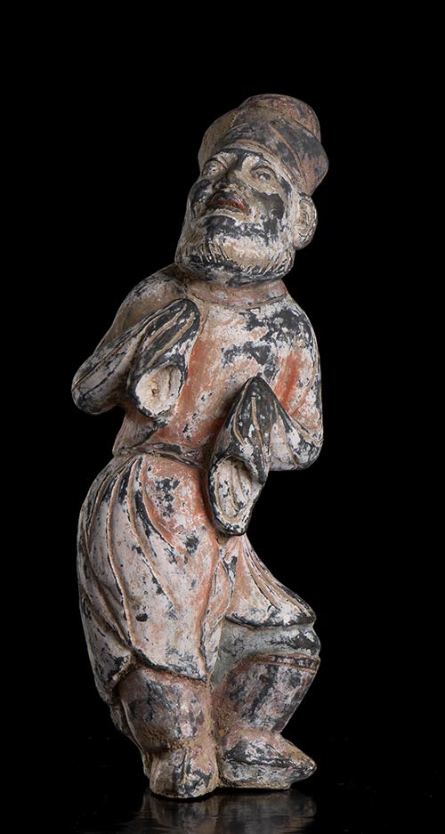 A PAINTED POTTERY FIGURE OF A ... 