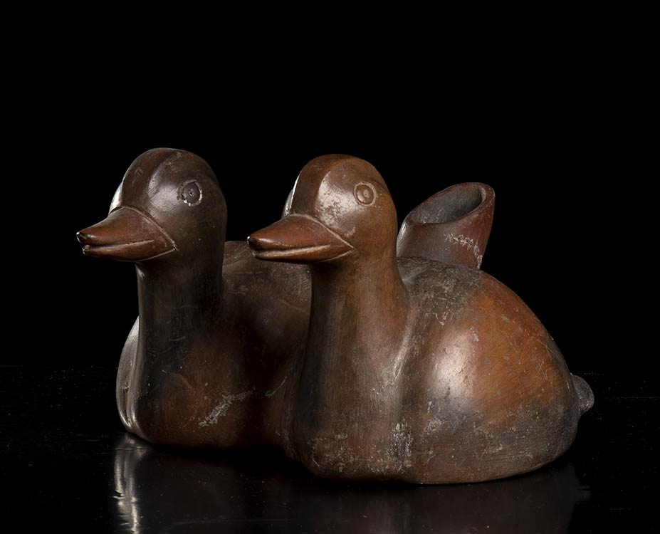 A POTTERY EWER SHAPED AS TWO DUCKS ... 