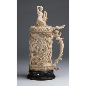 A carved ivory tankard depicting ... 