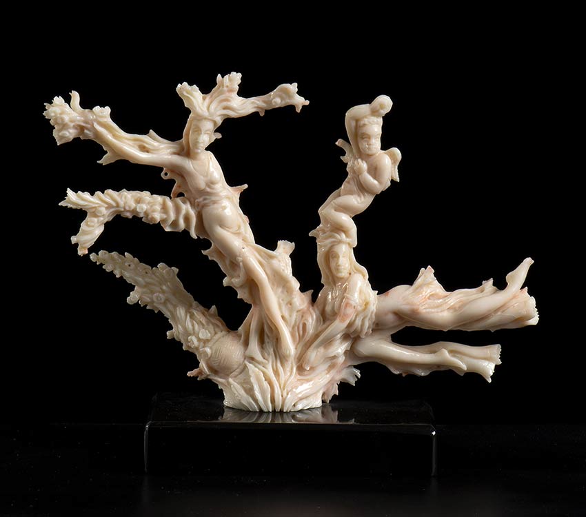 A PINK CORAL SCULPTURE WITH ... 