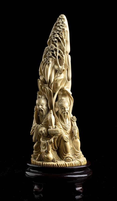AN IVORY GROUP WITH A MOUNTAIN AND ... 