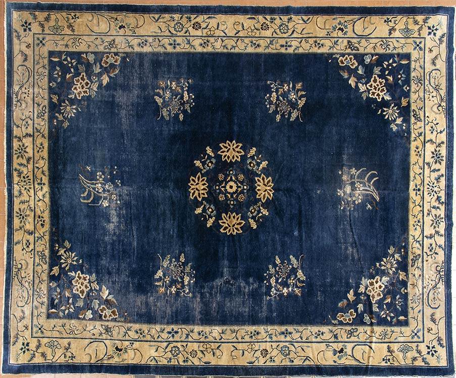 A BLUE GROUND CARPET WITH FLORAL ... 