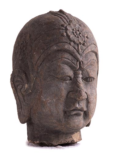 A LARGE STONE HEAD OF A ... 