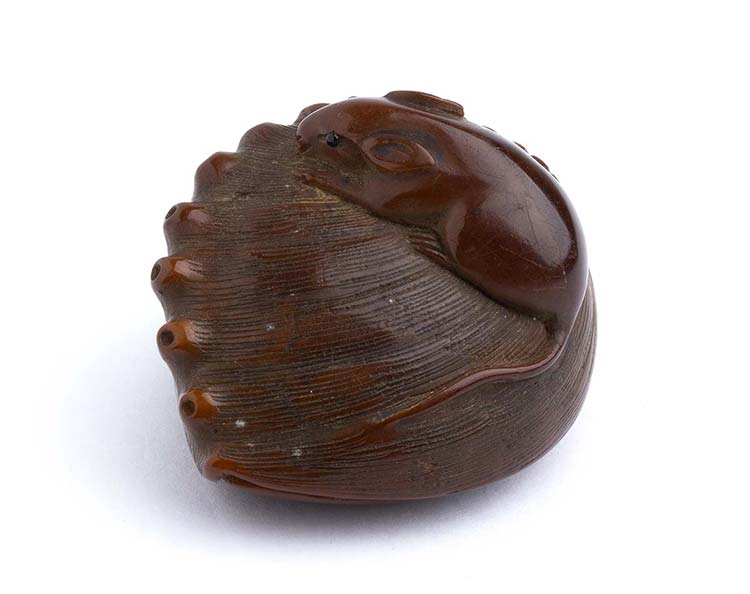 A WOODEN AND HORN INLAID NETSUKE ... 