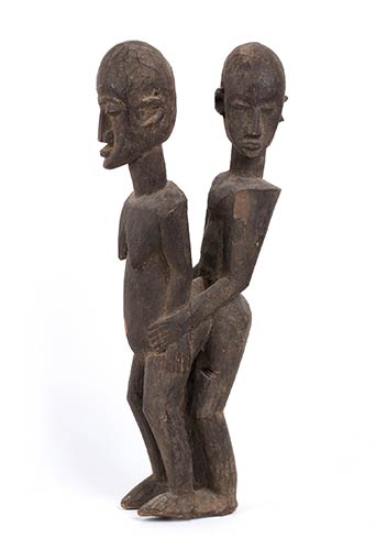 A WOOD SCULPTURE OF A MALE AND ... 