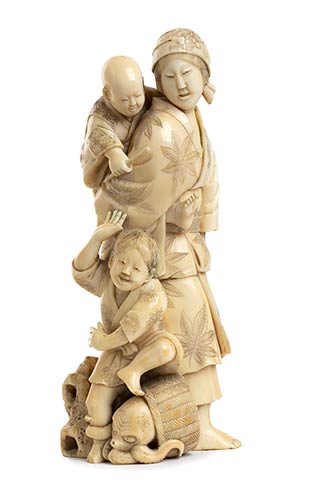 AN IVORY OKIMONO OF A MOTHER AND ... 