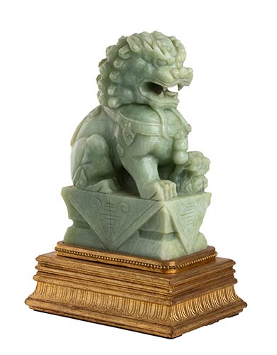 A CARVED GREEN HARDSTONE BUDDHIST ... 