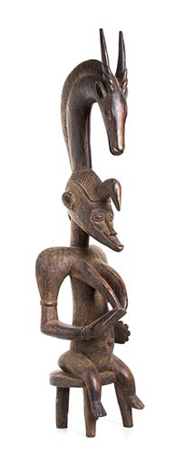 A WOOD FEMALE FIGURE WITH ANTELOPE ... 