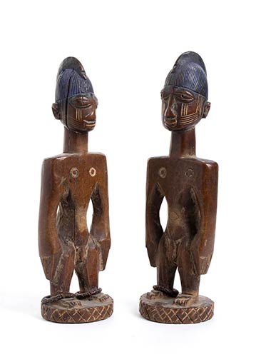A PAIR OF YORUBA PAINTED WOOD ERE ... 