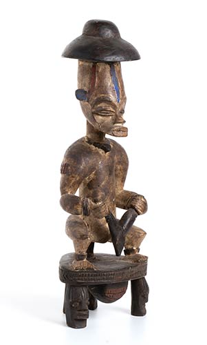 A PAINTED WOOD SEATED MALE FIGURE ... 