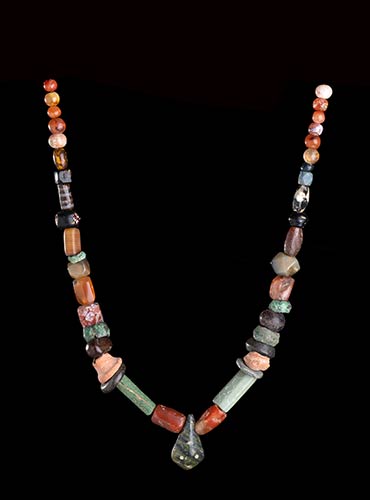 A GLASS, STONE AND POTTERY BEADS ... 