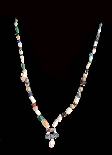 A STONE, GLASS AND BRONZE BEADS ... 