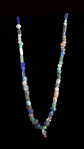 TWO GLASS, STONE AND FAIENCE BEADS ... 