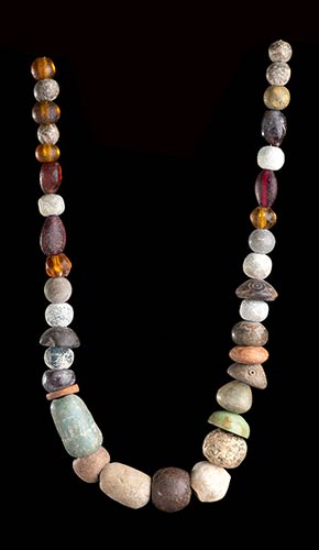 A STONE, GLASS AND POTTERY BEADS ... 