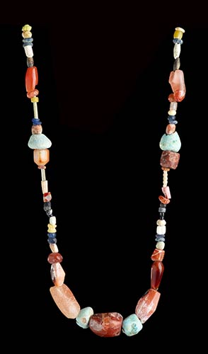 A FAIENCE, GLASS AND STONE BEADS ... 