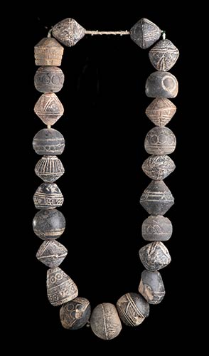 AN INCISED POTTERY BEADS ... 