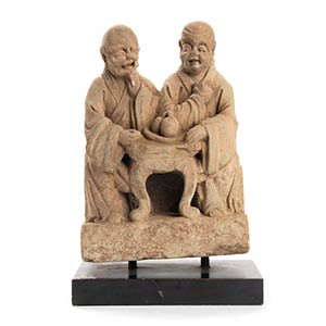 A STONE SCULPTURE OF TWO SEATED ... 