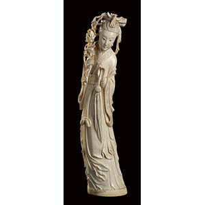 AN IVORY CARVING OF A STANDING FEMALE FIGURE ... 