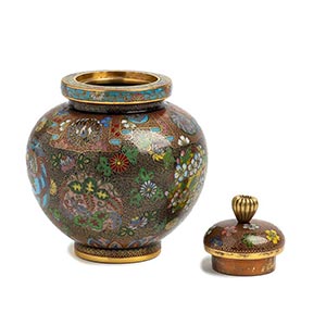 A SMALL METAL VASE AND COVER WITH ... 