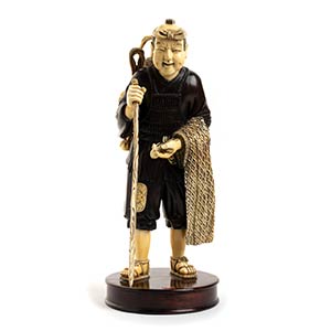 A WOOD AND IVORY FIGURE OF A FISHERMANJapan, ... 