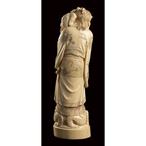 AN IVORY CARVING OF A STANDING ... 