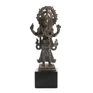 A SILVER ALLOY STANDING FOUR-ARMED ... 