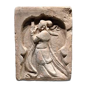 A MOLDED POTTERY TILE WITH A FEMALE ... 