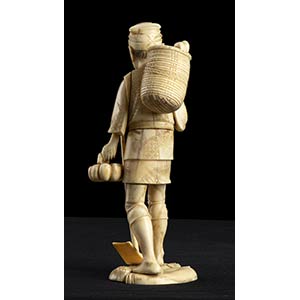 AN IVORY OKIMONO WITH A STANDING ... 