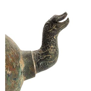 A BRONZE HANDLED AND SPOUTED ... 