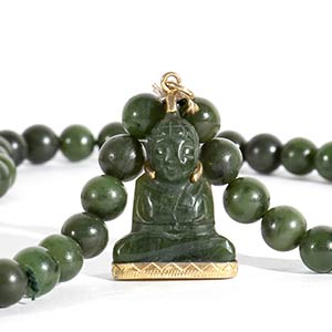A SPINACH GREEN JADE BEADS ... 