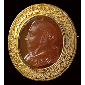 A carnelian cameo mounted in a gold brooch. ... 