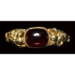 A modern gold ring with a garnet stone. 20th ... 