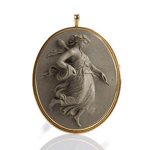 A gold mounting lava stone cameo depicting a ... 