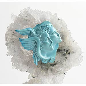 A turquoise sculpture depicting ... 