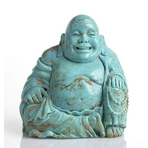A turquoise sculpture depicting a smiling ... 
