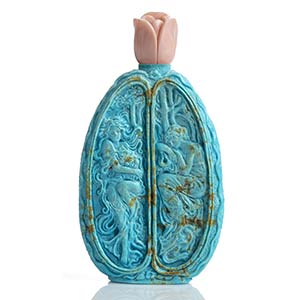 A turquoise bottle shaped sculpture with ... 