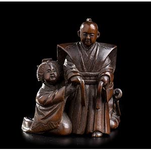 A WOOD NETSUKE WITH A SAMURAI AND TWO ... 