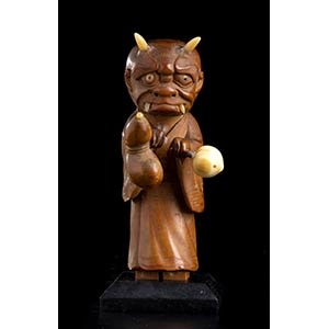 A WOOD, IVORY AND HORN OKIMONO OF A ONI ... 