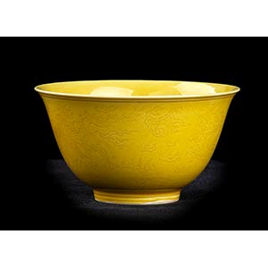 A YELLOW GLAZED AND INCISED PORCELAIN ... 