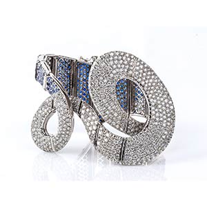 Gold ribbon bracelet with diamonds and blue ... 