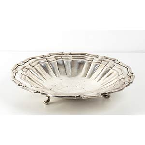 Silver basket and bowlof shaped form resting ... 